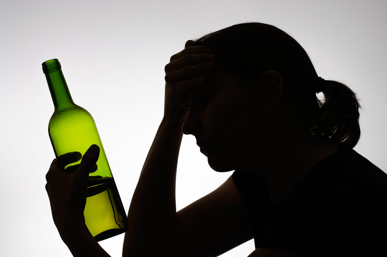 Silhouette Of A Woman Holding A Bottle