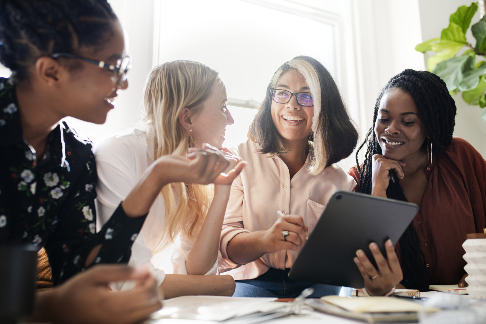 Fashion designers having a meeting using a digital tablet