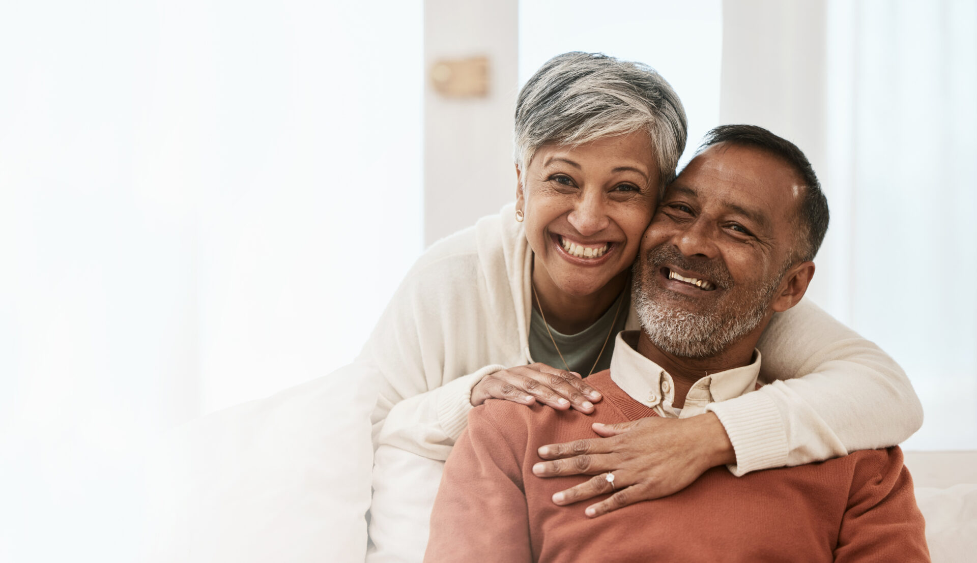 portrait-smile-senior-couple-home-living-room-bonding-together-hug-mockup-space-happy-face-man-indian-woman-lounge-care-love-support-healthy-relationship-house