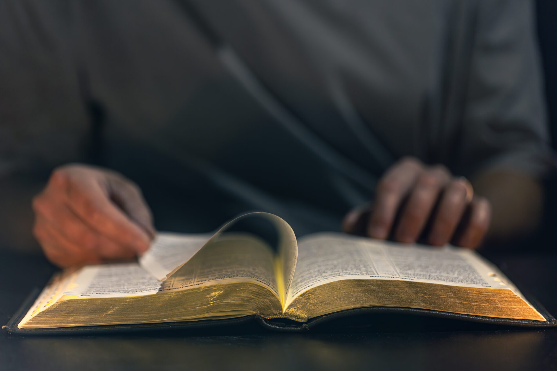 A man reads the Bible. Male hands with Bible close-up