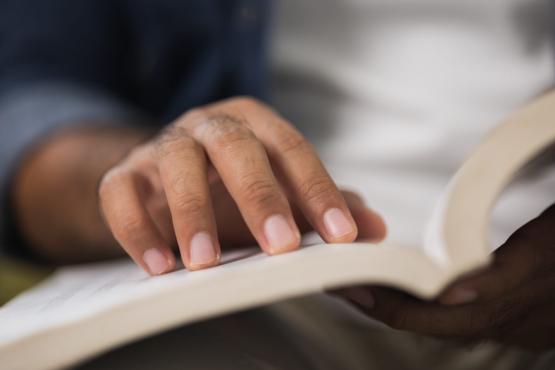 Close up male hand open book and reading